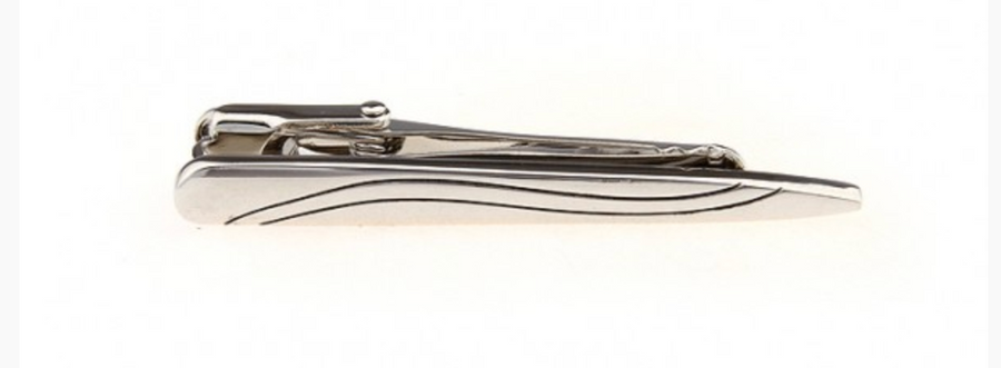 a silver tie clip with an embossed line through it 