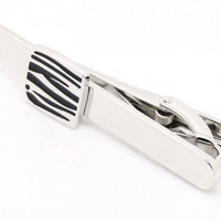 mens tie clip in silver chrome with a black and silver design on the clip