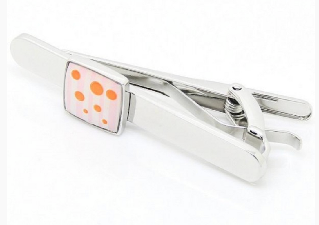 a silver mens tie clip with pink and orange stripe and spot design