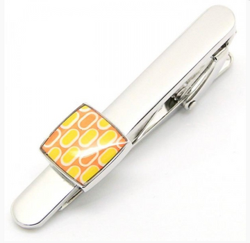 Silver tie clip with an orange and yellow square feature on the end