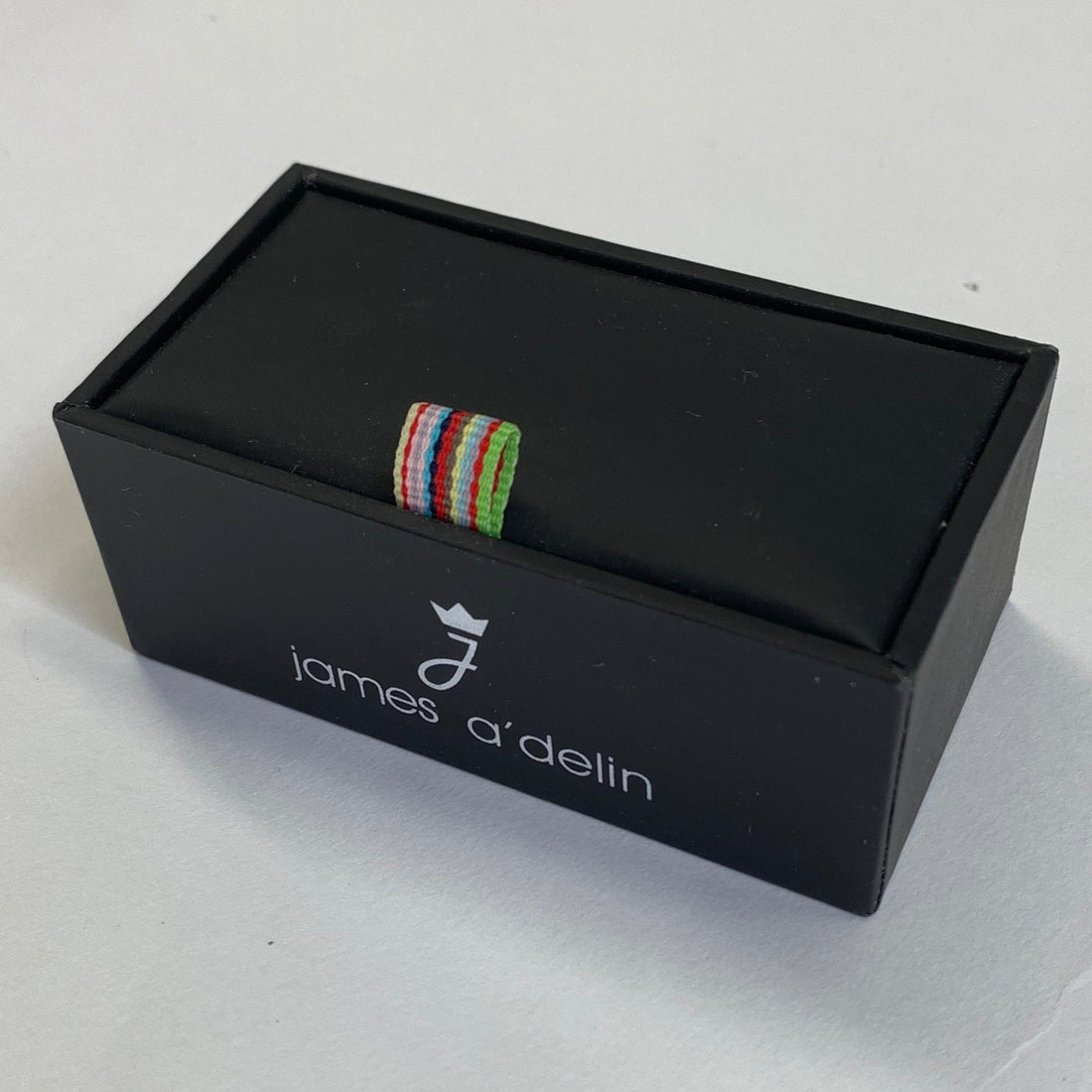 a small gift box with mens tie clips inside